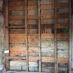 The fully exposed window opening, shiplap and studs cover the opening